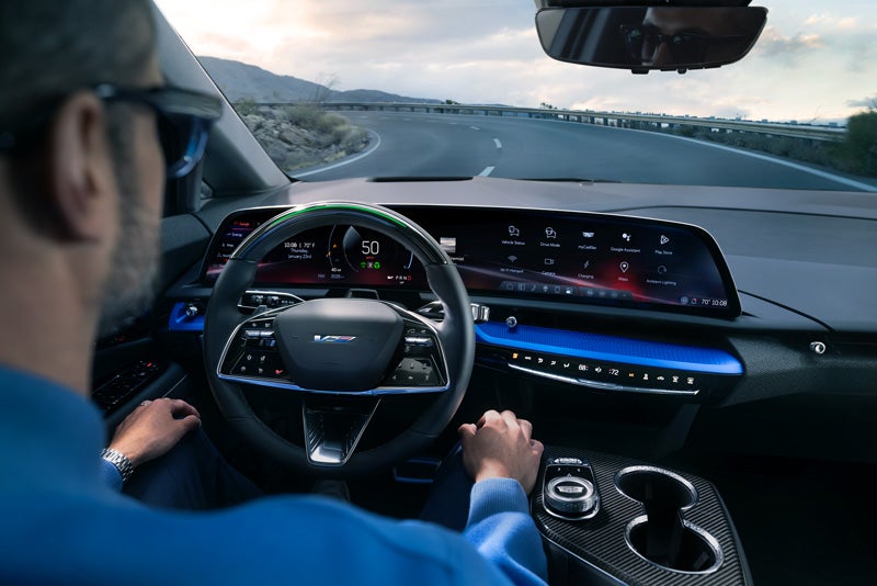 Front View of the 2026 OPTIQ-V Driving Through the Dusk Utilizing its Headlights | James E. Black Cadillac in Ebensburg PA